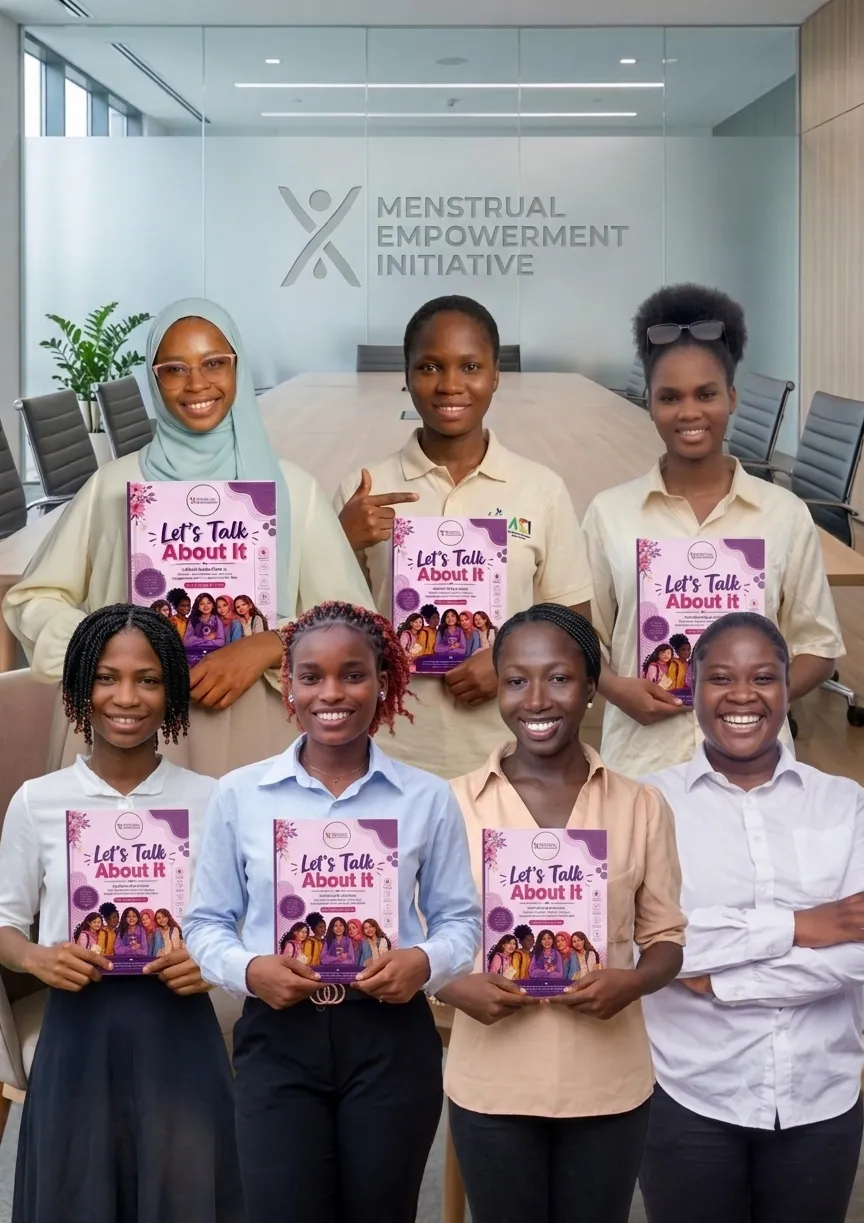 The MEI team holding copies of the Let's Talk About It book
