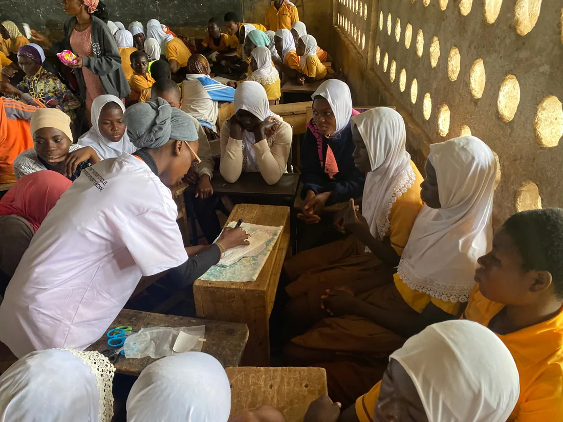 Girls seated at desks during a reusable pad training session
