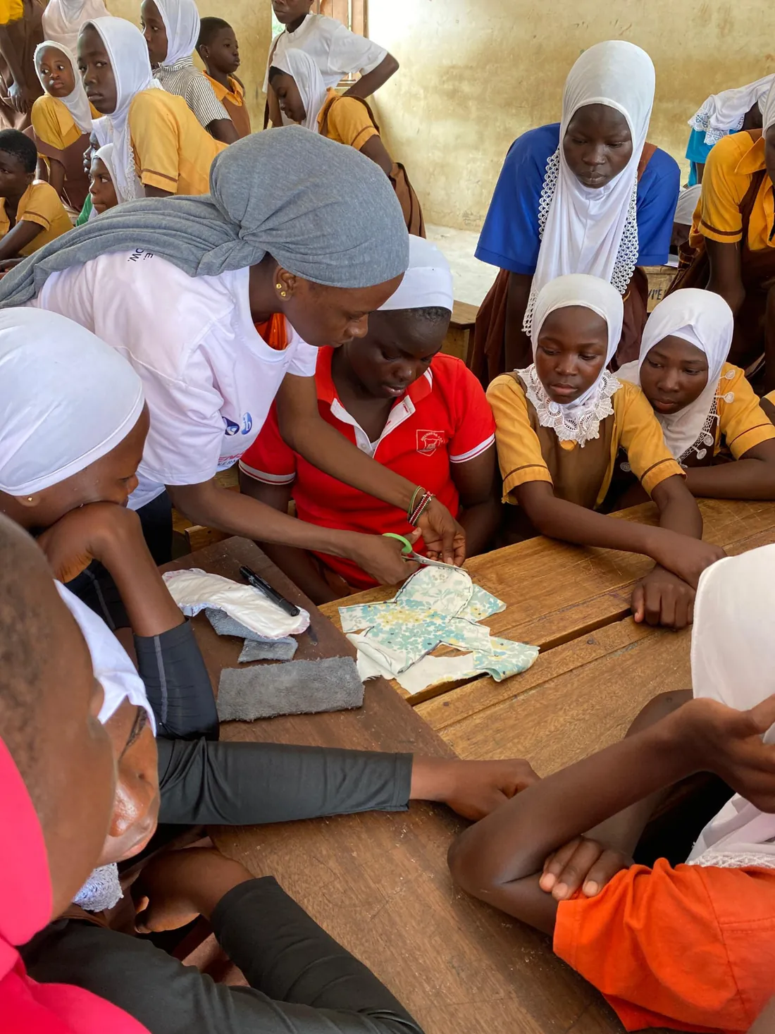 MEI facilitator guiding girls through pad production