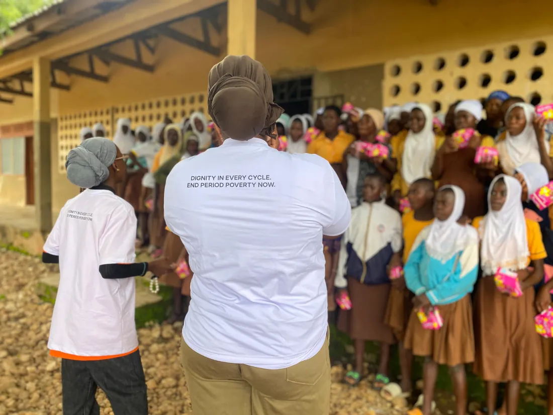 MEI team distributing menstrual pads to schoolgirls